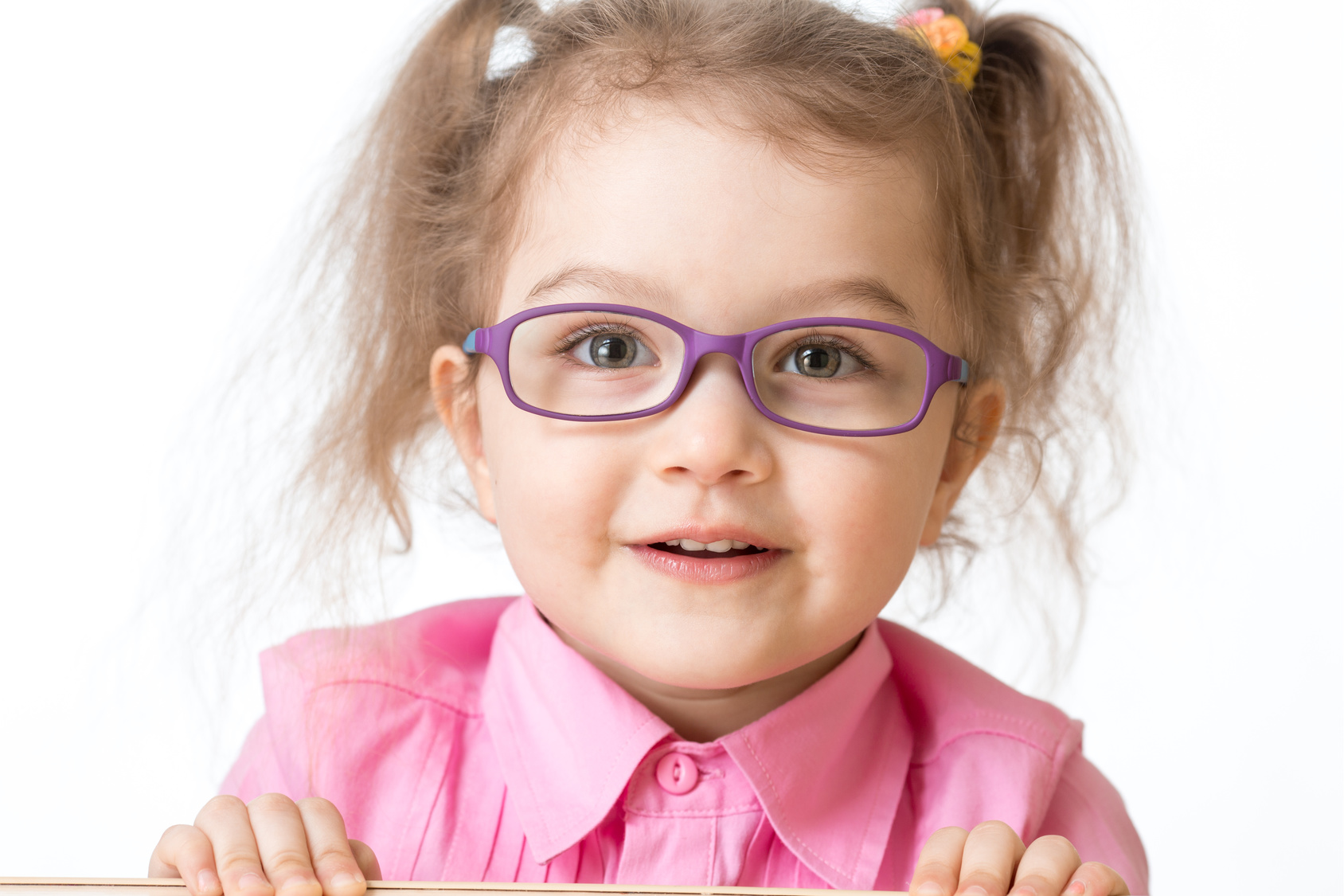 Smiling girl wearing glasses closeup portrait isolated